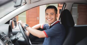 Professional chauffeur driving an executive vehicle, highlighting the productivity benefits of executive transportation for business travelers.