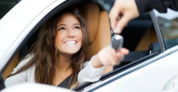 Customer receiving car keys for a monthly SUV rental in San Francisco for an extended stay or business travel.